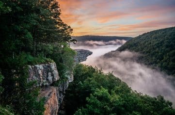 A colorful sunrise and fog at Whitaker Point / Hawksbill Crag.